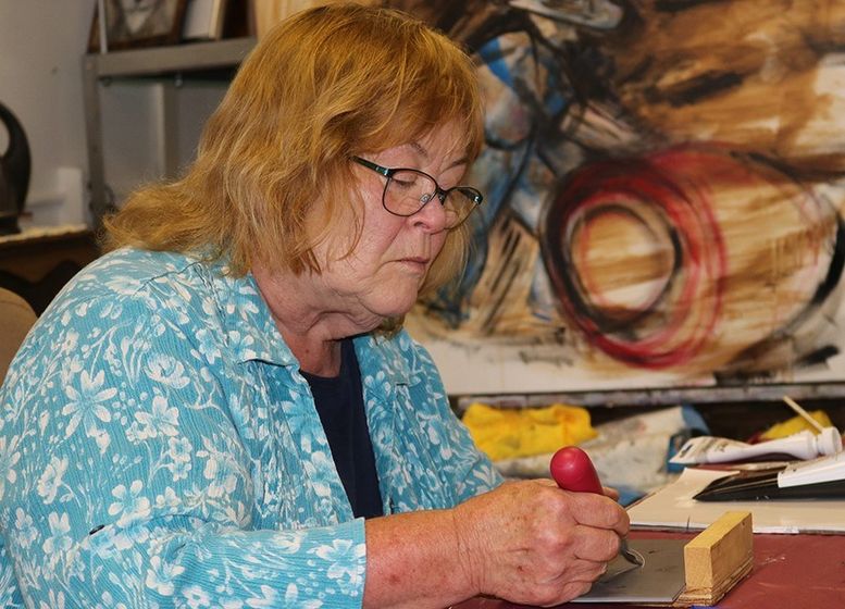 Di Filing works on a wood block print at Saddlebum Studio in Harrison.