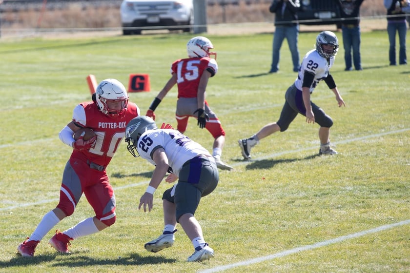 Potter-Dix Junior Jaxen Buettenback attempts to get around Garden County Freshman Kyan Kramer in the Coyotes, 55-8, victory over the Eagles on Friday, Oct. 14, 2022.