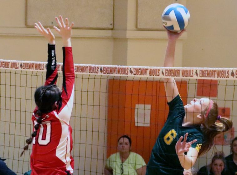Hay Spring’s Samantha Toof hits around Hemingford’s Kambree Walker Saturday at Panhandle Conference.