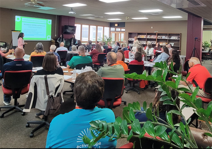 Sidney High School teachers present before members of the E3 during a tour of Sidney in September 2022.