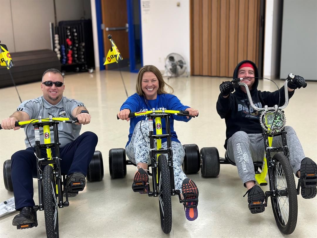 987 The Big Boy's Justin Richards and Hunter Arterburn challenge Tara Gray, from the Cheyenne County Community Center, to a Big Wheel race on March 29 in Sidney.