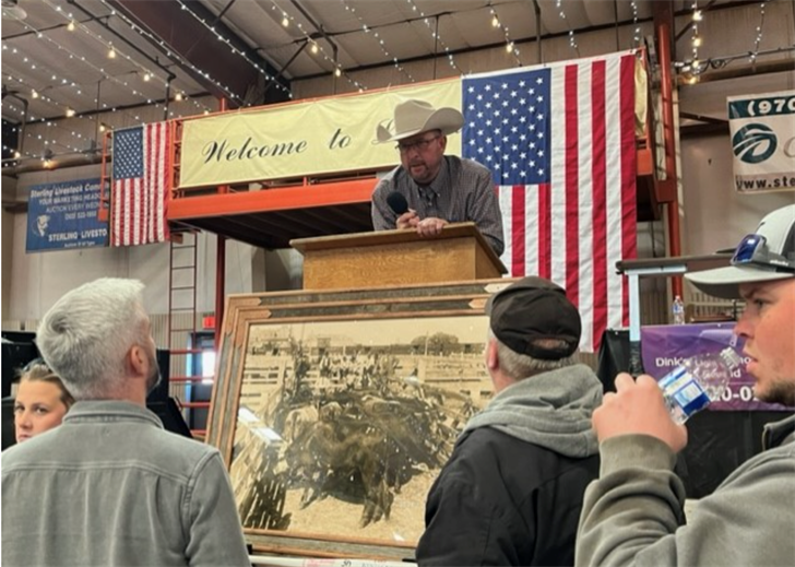 Jason Santomaso, center, owner/manager Sterling Livestock commission, chats with supporters of the 2023 Meat-In.