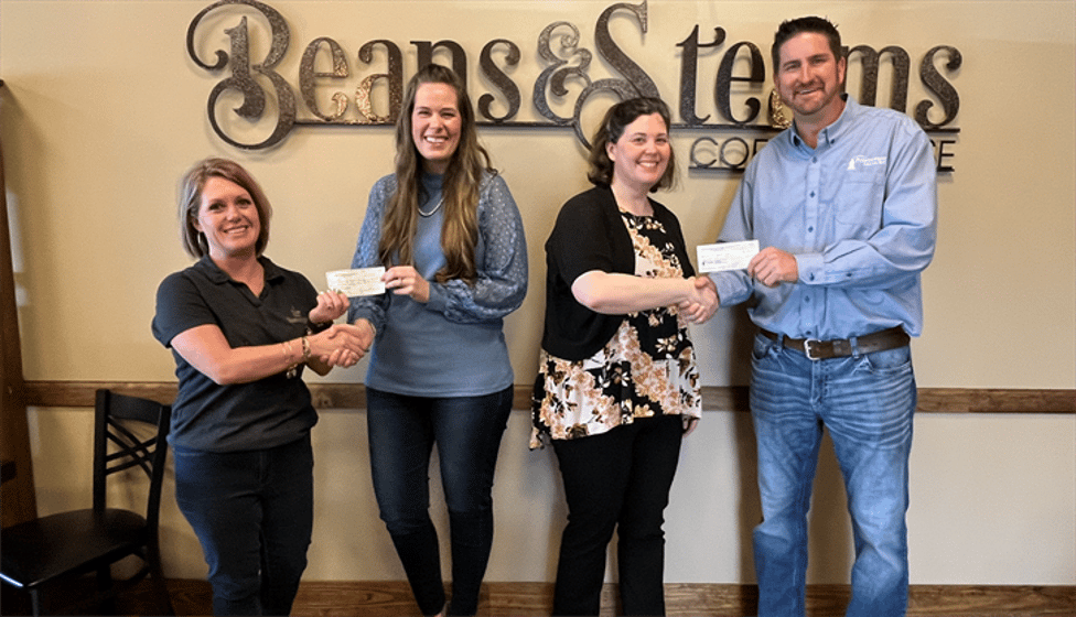 Pictured from left are Kiersten Richards (Beans & Steams Coffee House), Courtney Heesacker, Tabitha Adden, and Rick Heckenlively (Points West Bank). Beans & Steams Coffee House and Points West Bank made a donation to The Ark ministry.