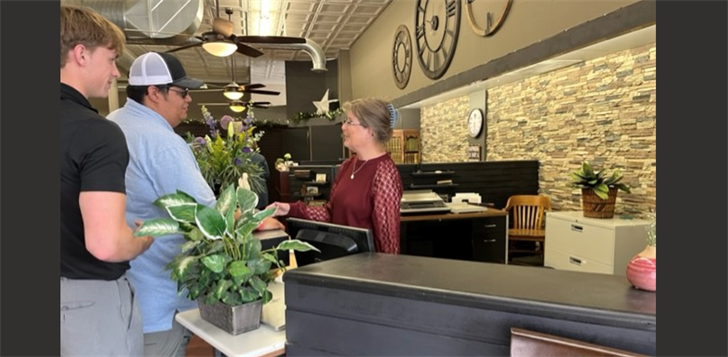 Big Boy 987 staff Cooper White and Chris Gutierrez congratulate Denise Feueborn on her retirement from The Insurance Store in Sidney.