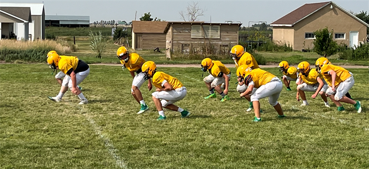 The Peetz Football team goes through stretching routines before starting practice recently.