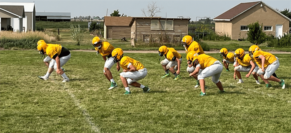 The Peetz Football team goes through stretching routines before starting practice recently.