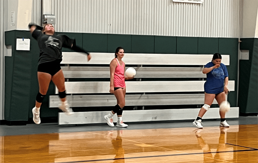 A jump serve, watching for reaction and preparing for a serve during a recent team practice.