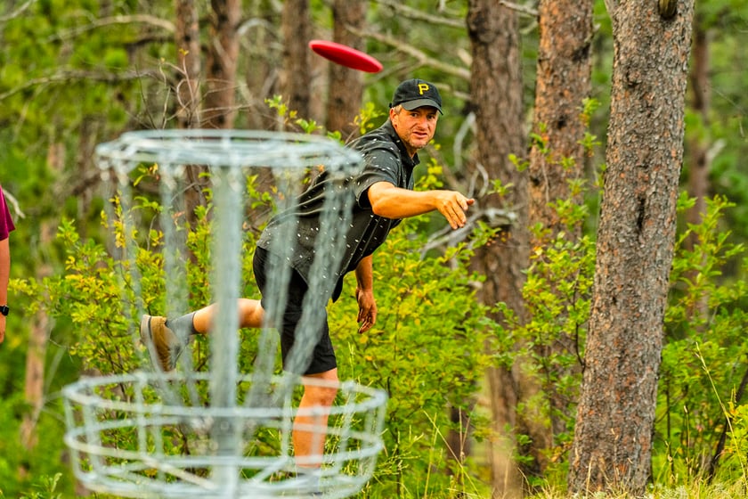Zane Hesting makes a throw during the weekly meeting of Chadron State Park's disc golf league in Dawes County. Several other Nebraska state park areas offer disc golf.