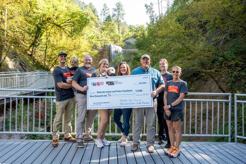 The family of Tyler Vanderheiden and annual memorial run representatives present a check for trails upgrades at Smith Falls State Park to Nebraska Game and Parks Commission representatives on Sept. 17 at the park near Valentine.
