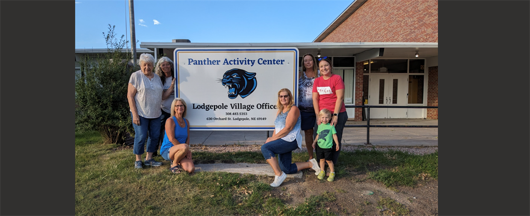 Pictured with the new Panther Activity Center sign - Janet Fox, Dana Hill (standing next to sign on the left), Toni Bruns (front left), Terry Christensen, (front right), Laurie Abrams, Trinity Oliverius and Waylon Oliverius.