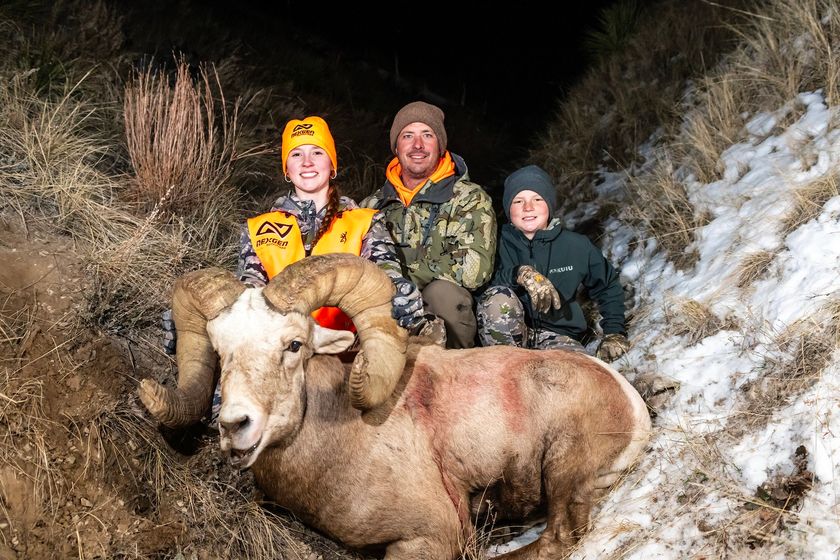 Kiersten, Trevor and Reed Black poses with the bighorn sheep ram after Kiersten's successful hunt.
