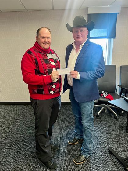 WNCC President Greg Dart accepts a $15,000 donation from Rusty Kemp, NPPD board member, from the 32nd annual Nebraska Open golf tournament.