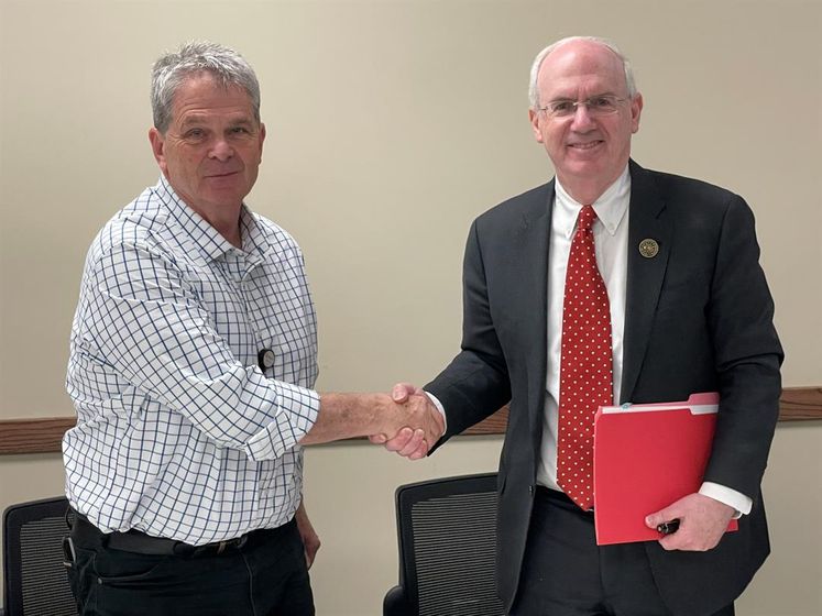 Mel McNea, Regional West CEO, and Jeffrey P. Gold, MD, University of Nebraska Medical Center chancellor, finalize the agreement between Regional West Health Services and UNMC.