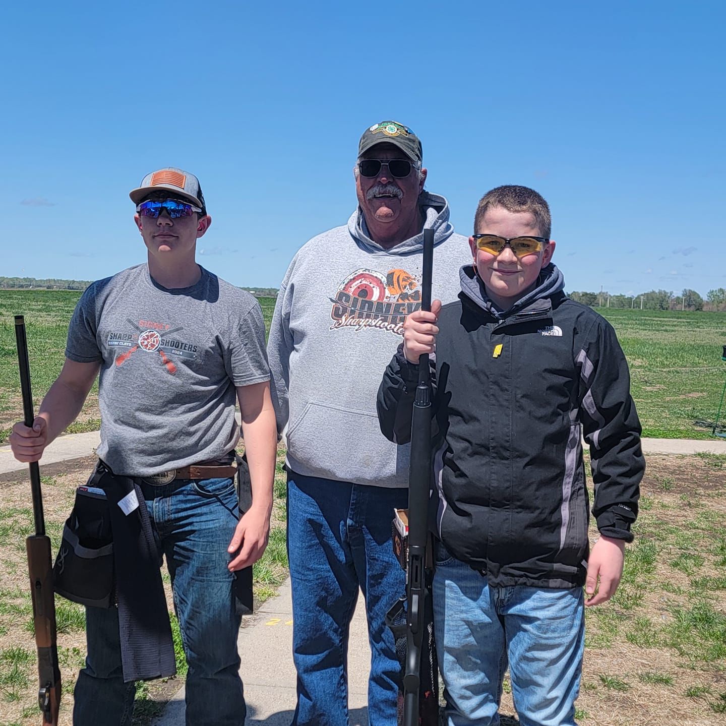Sidney Sharpshooters Colt Van Anne and Owen Craig competed in the Junior Shoot Thursday. Van Anne finished the year with an 83 and Craig with a 42. Also in the picture is Tom Noel their coach.