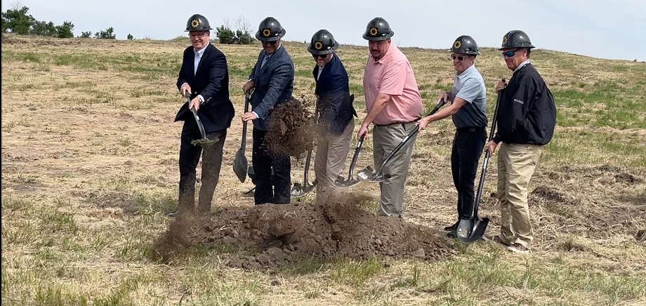 Sidney and company officials turn the first shovels of dirt leading to a new solar energy facility near Sidney.