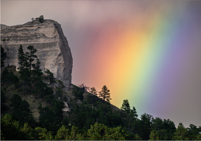 People with common vision would see the full spectrum of color in this rainbow behind Giant's Coffin Butte at Fort Robinson State Park.