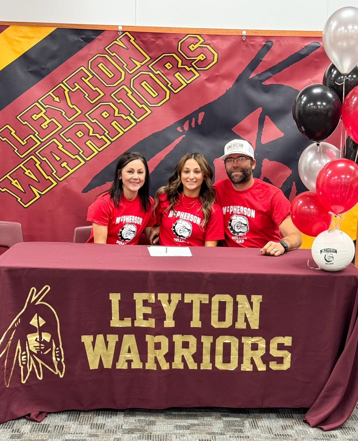 Leyton senior volleyball player signed her letter of intent to play at McPherson College in Kansas on Wednesday, surrounded by her mom Natasha and dad Richard.