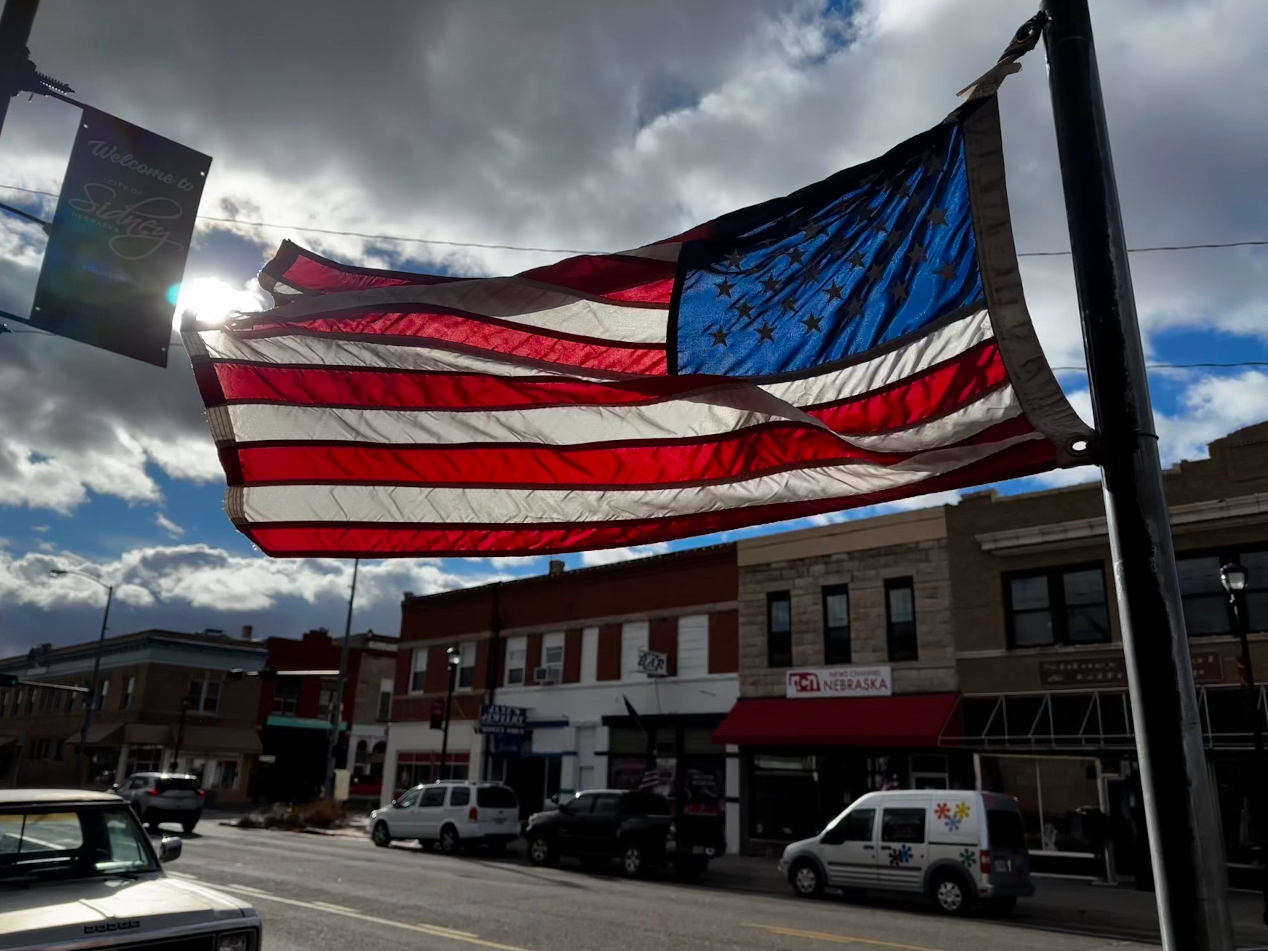 Strong wind gusts whip an American flag in Hickory Square in Sidney on Monday, Dec. 30, 2024. A high wind warning was in effect until 5 p.m.