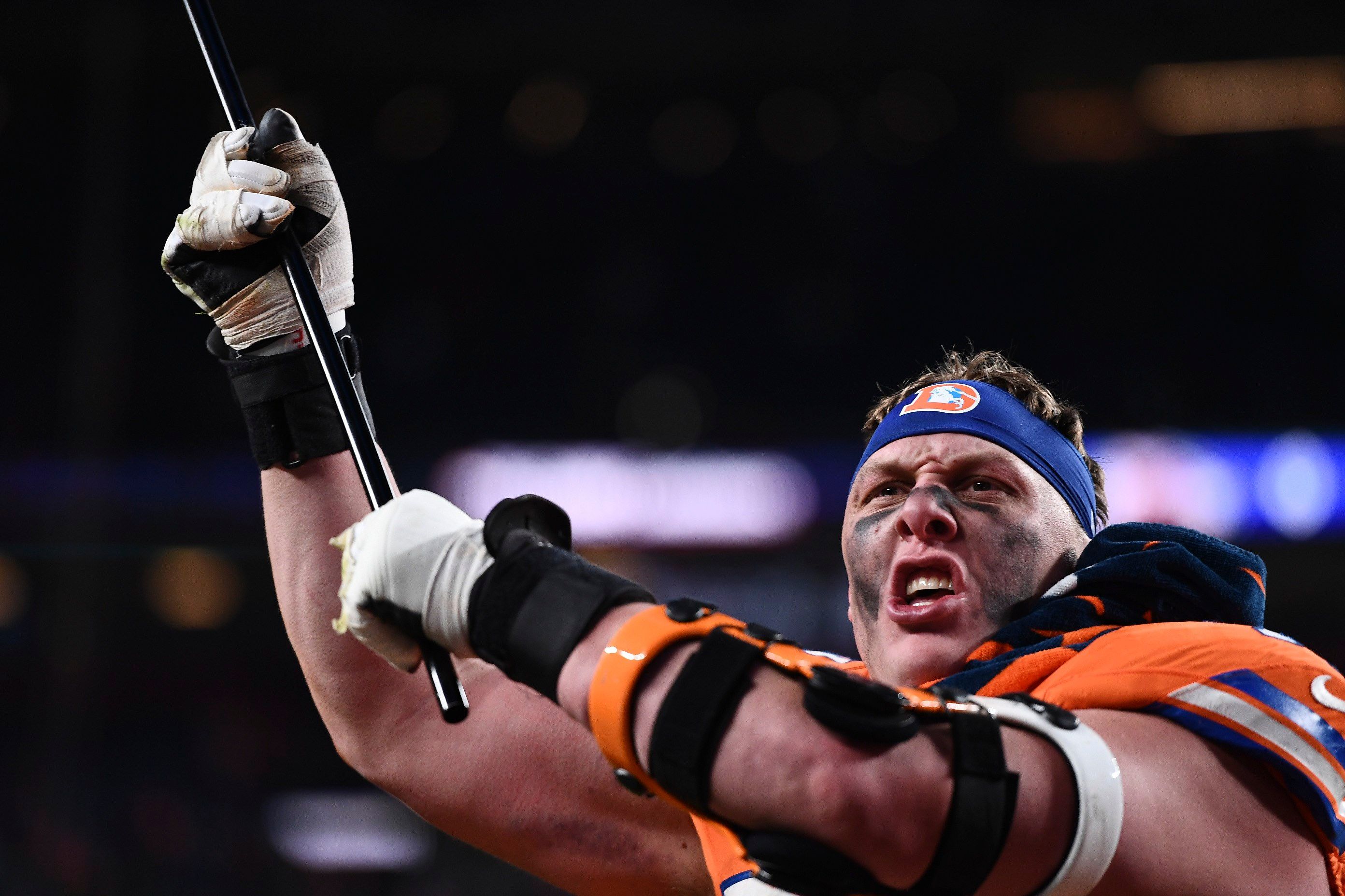 Denver Broncos offensive tackle Garett Bolles waves a flag after an NFL football game against the Kansas City Chiefs, Sunday, Jan. 5, 2025, in Denver.