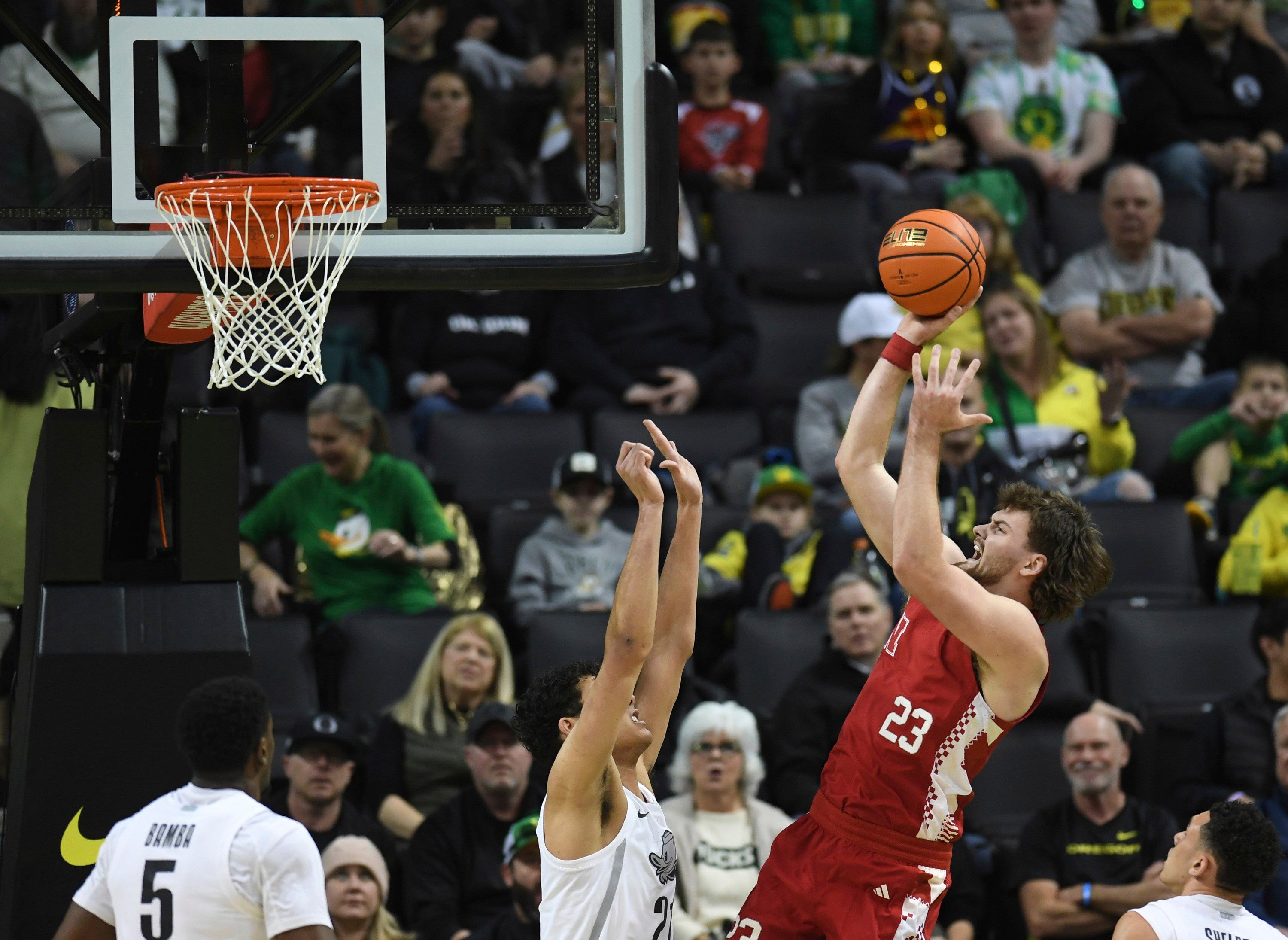 Nebraska forward Andrew Morgan (23) shoots over Oregon forward Brandon Angel, center, during an NCAA college basketball game Sunday, Feb. 2, 2025, in Eugene, Ore.