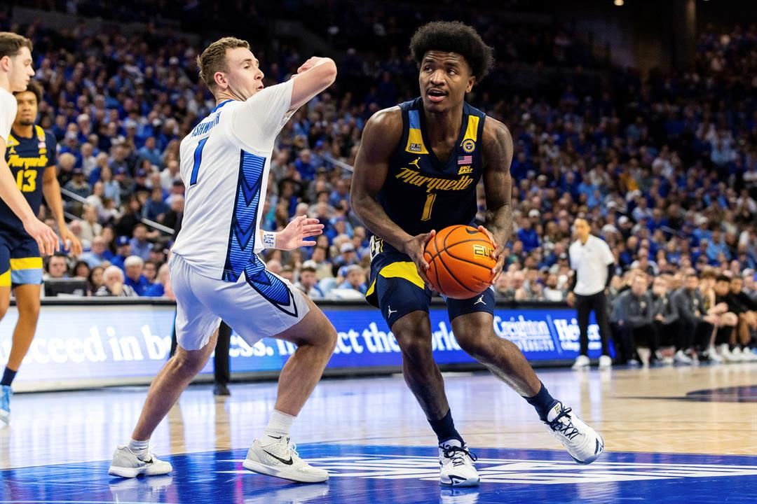 Marquette guard Kam Jones (1) drives inside against Creighton guard Steven Ashworth (1) during the first half of an NCAA college basketball game, Saturday, Feb. 8, 2025, in Omaha, Neb.