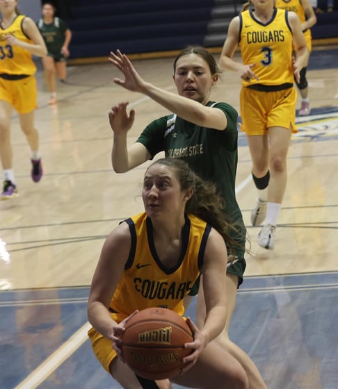 WNCC's Katie Vierra looks to go up for a shot while being guarded by CSU Club's Carlie Ellwood.