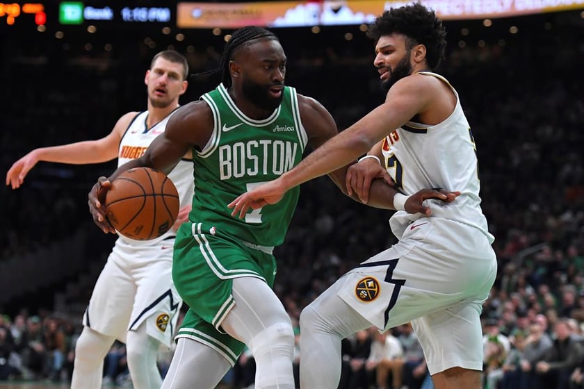 Boston Celtics guard Jaylen Brown, center, drives past Denver Nuggets guard Jamal Murray, right, in the first half of an NBA basketball game, Sunday, March 2, 2025, in Boston.