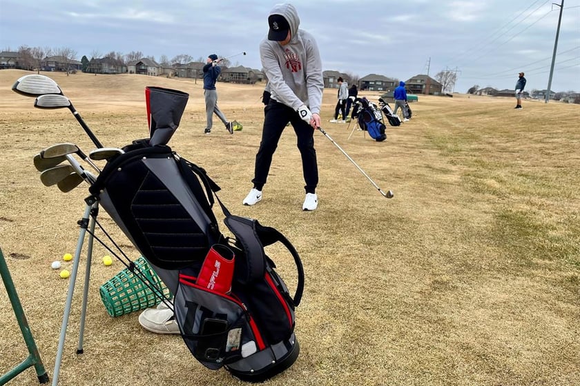 Golfers line up to take some practice shots on the driving range of the Stone Creek Golf Course in Omaha, Neb. on Monday afternoon, March 3, 2025, before hitting the links.