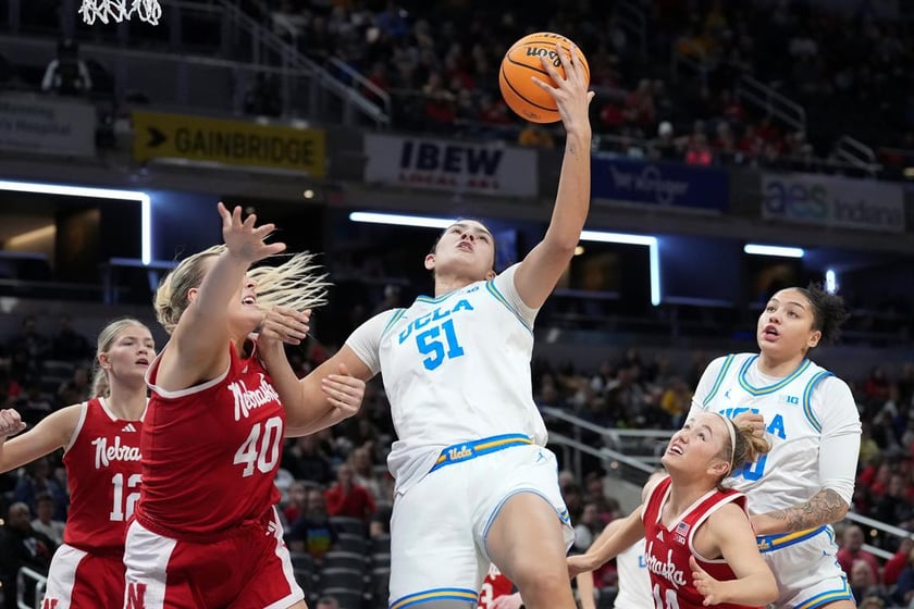UCLA center Lauren Betts (51) pulls down a rebound from Nebraska center Alexis Markowski (40) during the second half of an NCAA college basketball game in the quarterfinals of the Big Ten Conference tournament in Indianapolis, Friday, March 7, 2025.