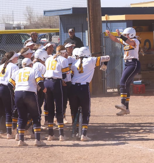 Lydia Tibbals gets ready to jump on home plate and then get mobbed by her teammate safter hitting the 2-run walk-off home run against Lamar on Sunday.