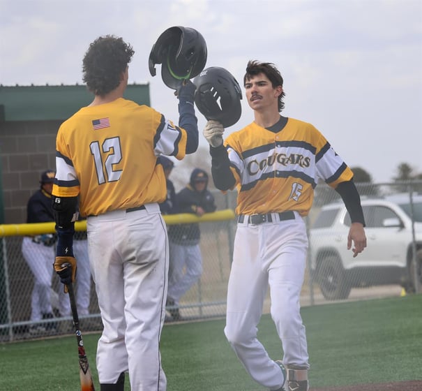 Vaughn Wilson is congratulated by his brother Cooper Wilson after hitting a home run in the second game of a doubleheader at Cleveland Field on Saturday. Wilson finished the day hitting for the cycle with a single, double, triple, and this home run.