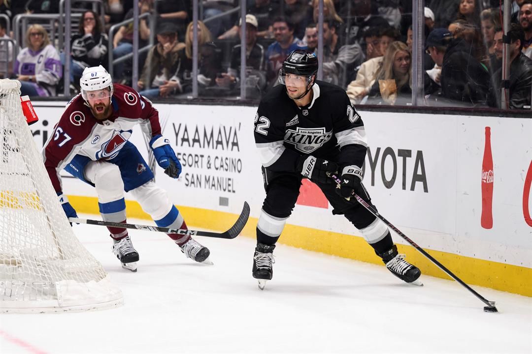 Los Angeles Kings left wing Kevin Fiala, right, looks to pass the puck while under pressure from Colorado Avalanche defenseman Keaton Middleton during the second period of an NHL hockey game Saturday, April 12, 2025, in Los Angeles.