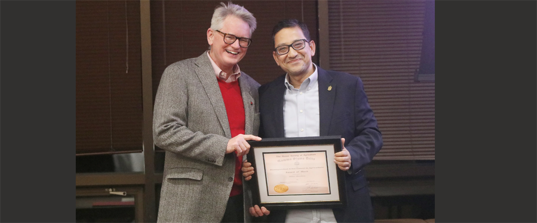 Panhandle Research Extension and Education Director John Westra, left, and Bijesh Maharjan, Nebraska Extension Specialist, with his award at the annual Gamma Sigma Delta banquet.