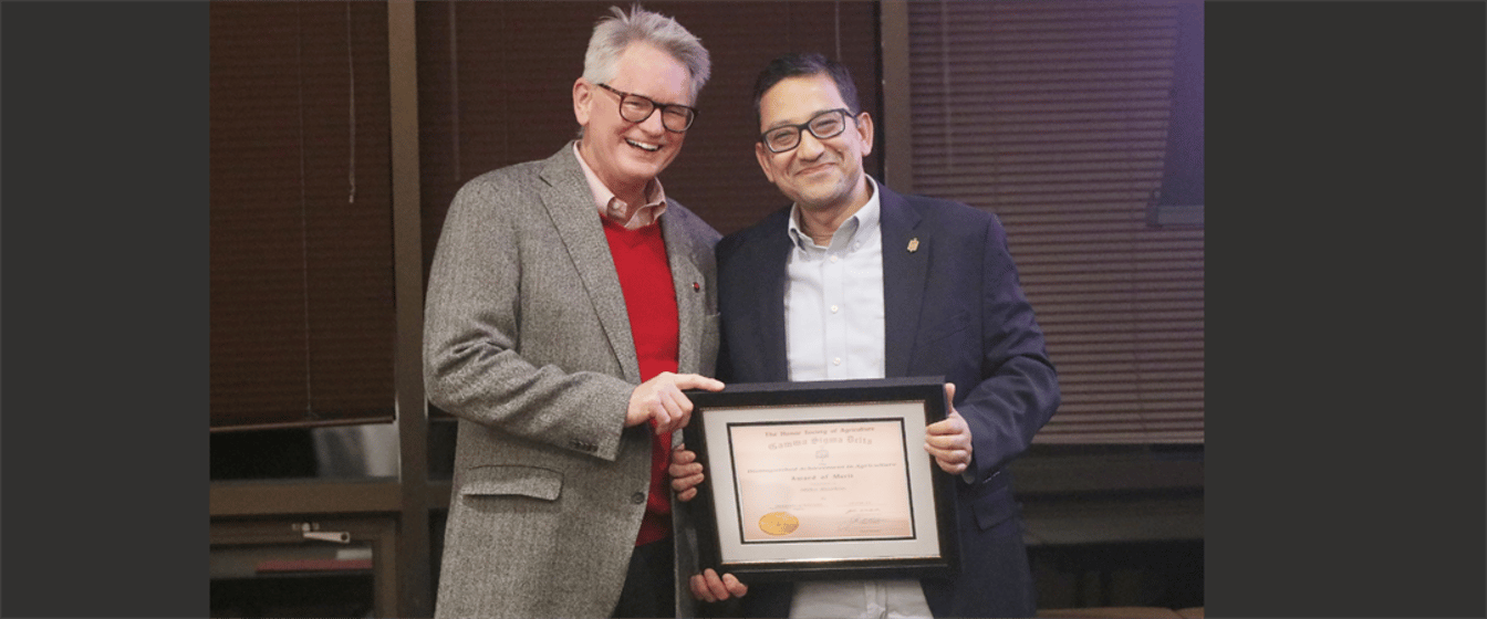 Panhandle Research Extension and Education Director John Westra, left, and Bijesh Maharjan, Nebraska Extension Specialist, with his award at the annual Gamma Sigma Delta banquet.
