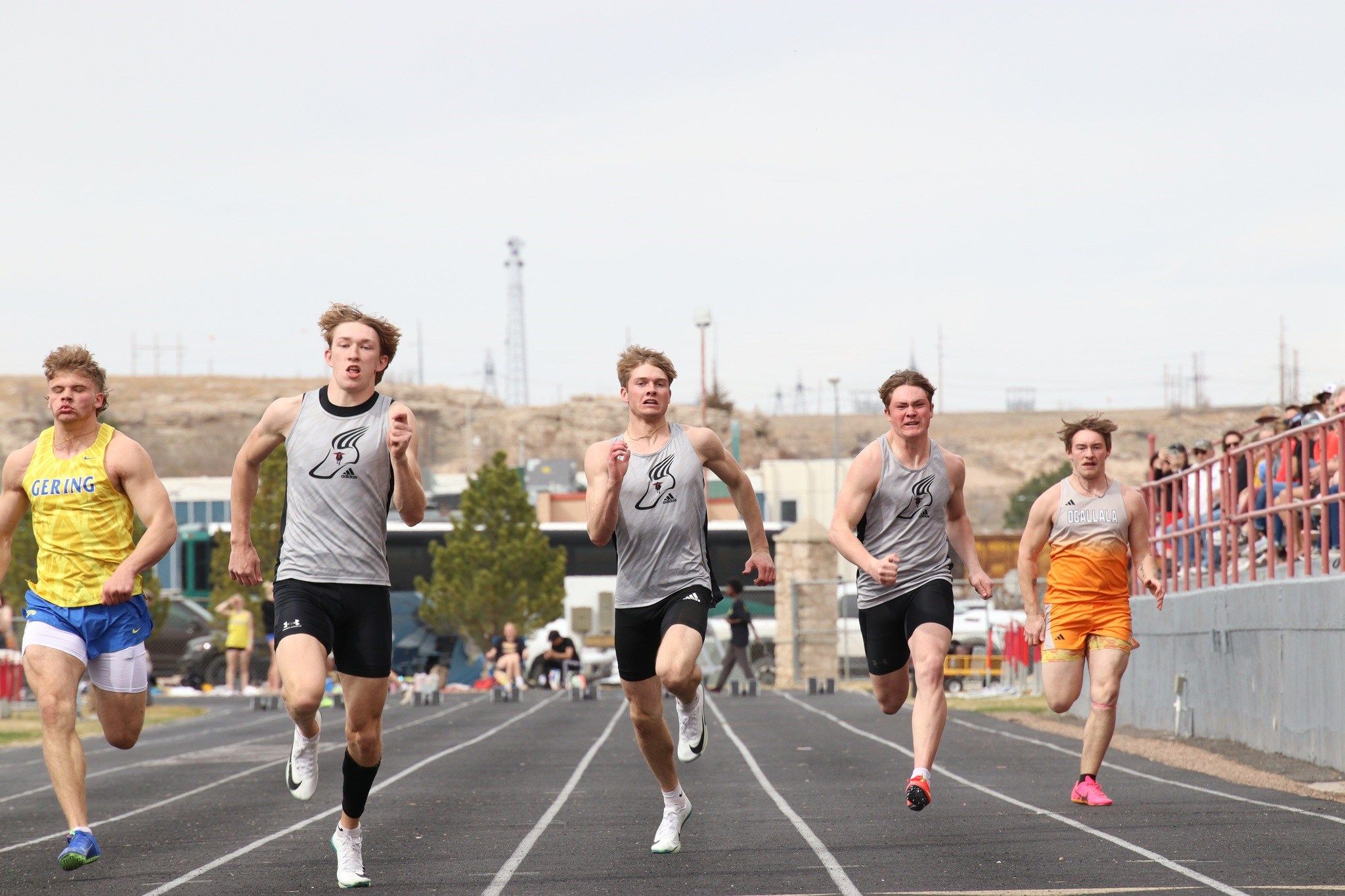Sidney's Lance Holly, Landon Riddle and Rhys Dorcey compete the boys 100-meter dash final at the John Ganser Invite at Sidney High School in late March 2025.