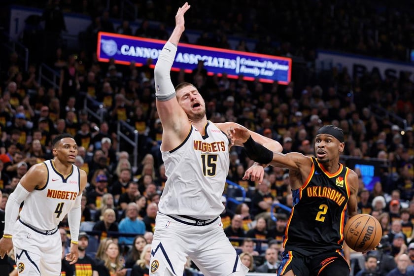 Oklahoma City Thunder's Shai Gilgeous-Alexander (2) works to the basket as Denver Nuggets' Nikola Jokic (15) and Russell Westbrook (4) defend in the second half of Game 1 of an NBA basketball second-round playoff series Monday, May 5, 2025.