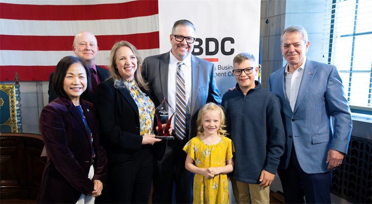 From left: UNO Chancellor Dr. Joanne Li, Nebraska DED Director K.C. Beliz, Stacy Dam, Dustin Dam, Cadence Dam, Porter Dam and Governor Jim Pillen.