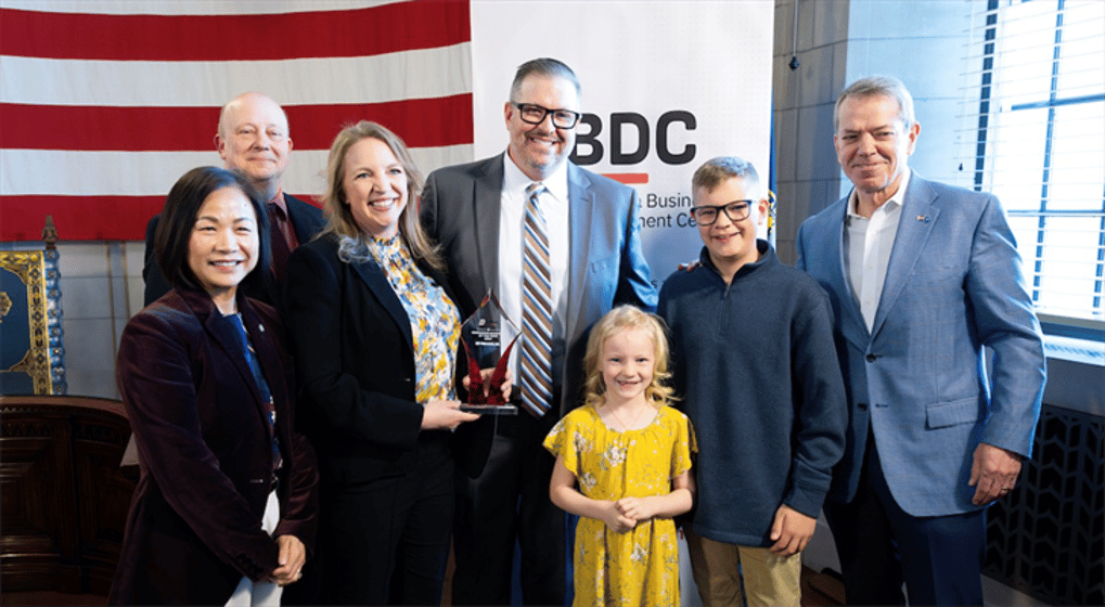 From left: UNO Chancellor Dr. Joanne Li, Nebraska DED Director K.C. Beliz, Stacy Dam, Dustin Dam, Cadence Dam, Porter Dam and Governor Jim Pillen.