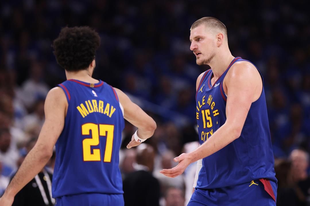Denver Nuggets' Jamal Murray (27) and Nikola Jokic (15) celebrate in the second half of Game 5 of an NBA basketball second-round playoff series against the Oklahoma City Thunder Tuesday, May 13, 2025, in Oklahoma City.
