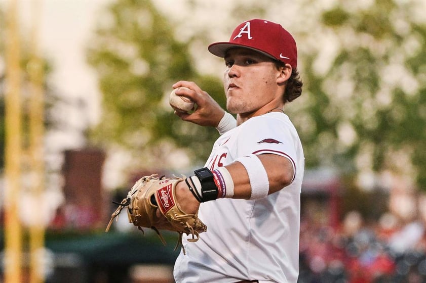 Arkansas infielder Cam Kozeal (8) throws during an NCAA colelge baseball game against Little Rock, Tuesday, April 22, 2025, in Fayetteville, Ark.