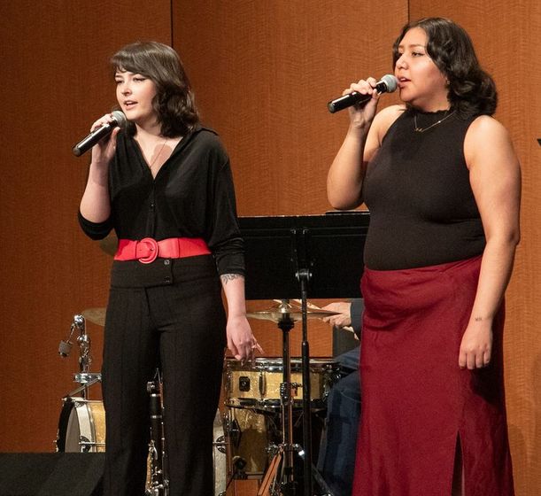 Chadron State College Vocal Jazz members Olivia Valadez of Alliance, Neb., left, and Rayne Charging Thunder of Gordon, Neb., right, perform on April 15, 2025, in the Memorial Hall Auditorium.