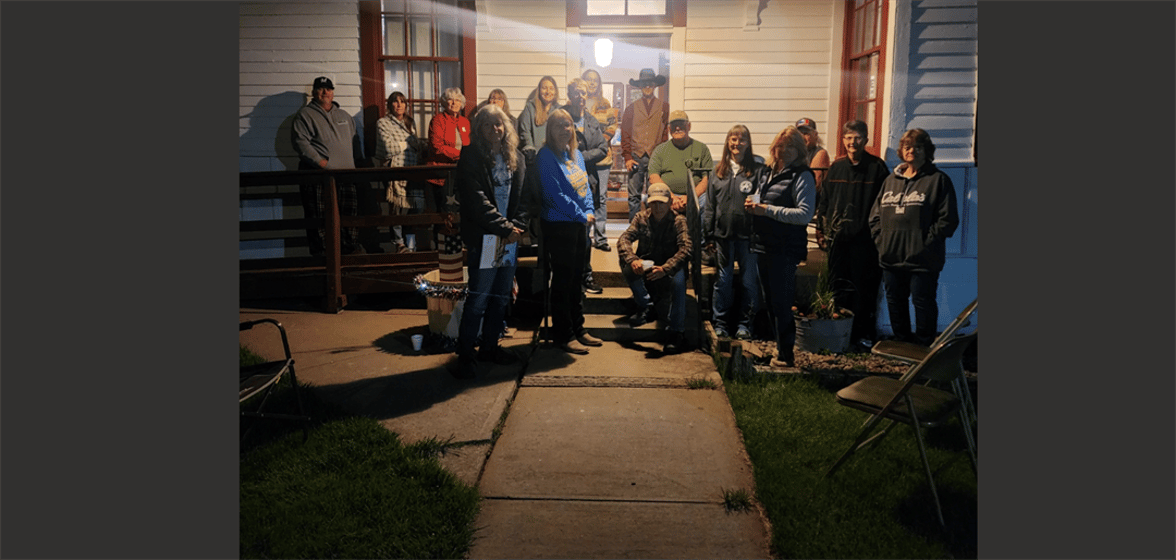 Residents gather to greet Gordy Wilkins and Kai Wilkins as they entered the village of Lodgepole.