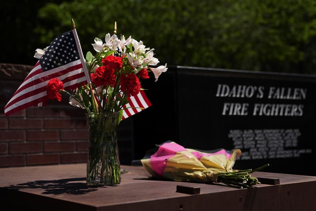 Flowers are seen at the Fallen Heroes Plaza at Cherry Hill Park near the scene the day after a shooter ambushed and killed firefighters responding to a wildfire at Canfield Mountain Monday, June 30, 2025, in Coeur D'Alene, Idaho.