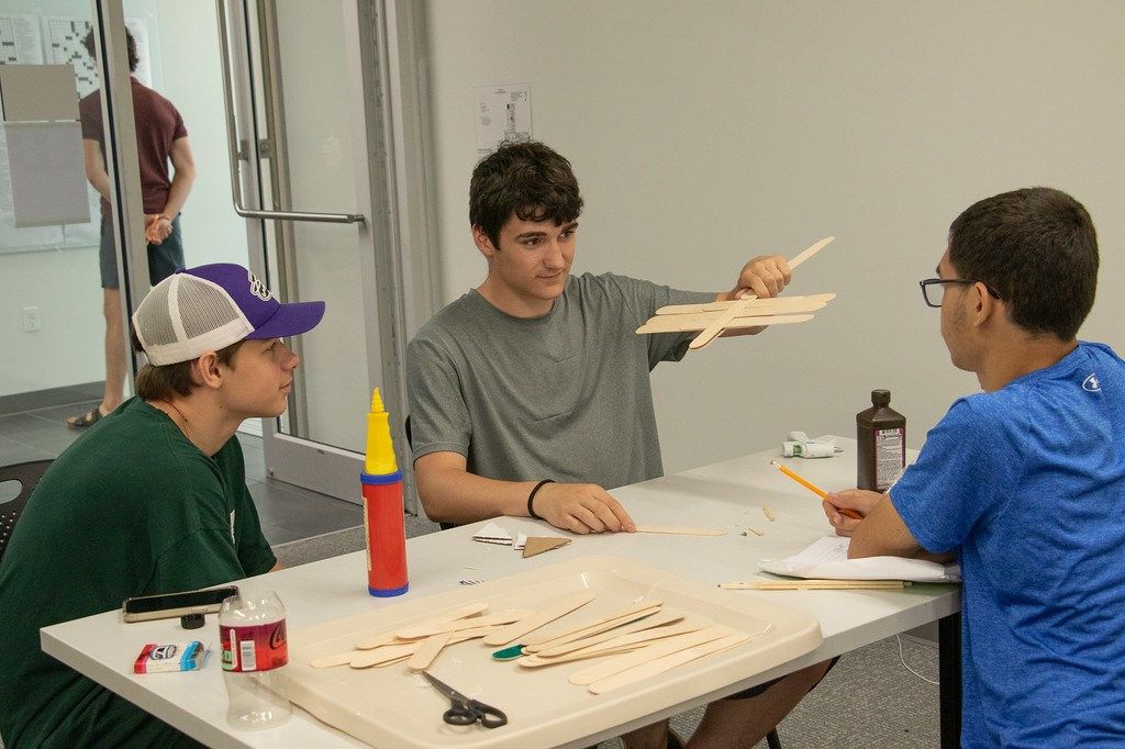 Upward Bound students, from left, Zachary Barton, Mason Horan, and Jordan Vergil build rockets in a science class June 12, 2025