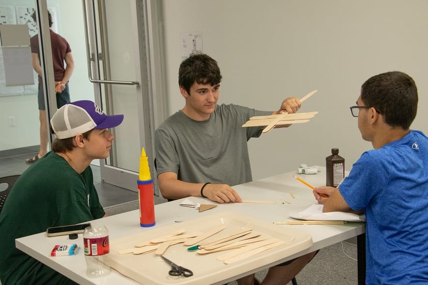 Upward Bound students, from left, Zachary Barton, Mason Horan, and Jordan Vergil build rockets in a science class June 12, 2025