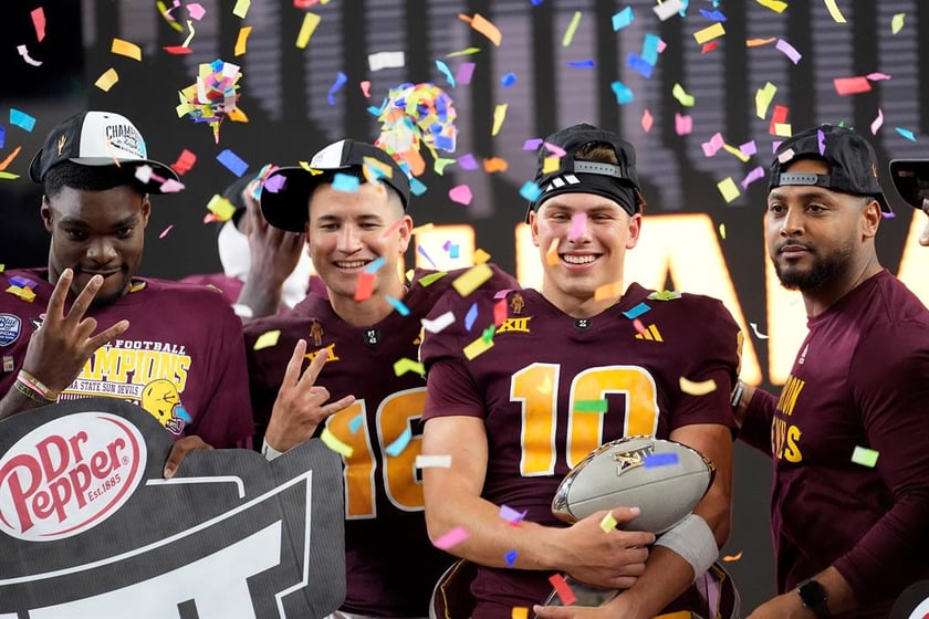 Arizona State quarterback Sam Leavitt (10) celebrates with teammates after the team's win in the Big 12 Conference championship NCAA college football game against Iowa State, in Arlington, Texas, Dec. 7, 2024.