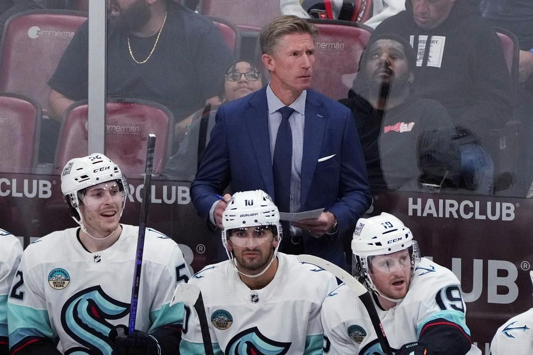 Seattle Kraken coach Dave Hakstol watches during the third period of the team's NHL hockey game against the Florida Panthers on Saturday, Oct. 28, 2023, in Sunrise, Fla.