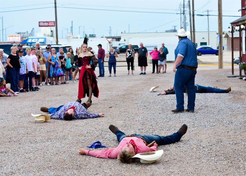 Tayvin Lutz (left) and Eben Rosentrater face off during a fake gunbattle on Ogallala’s Front Street during the July 24 performance of the Crystal Palace Revue. Photo by Bob Alberts for the Flatwater Free Press