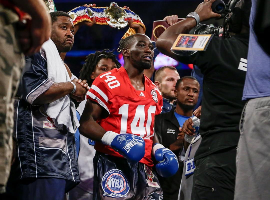 Terence "Bud" Crawford enters the ring in Lincoln, Neb., wearing a red No. 140 Nebraska Cornhuskers football jersey, a nod to this city being home to the University of Nebraska, for a junior welterweight world title unification bout against Julius Indongo