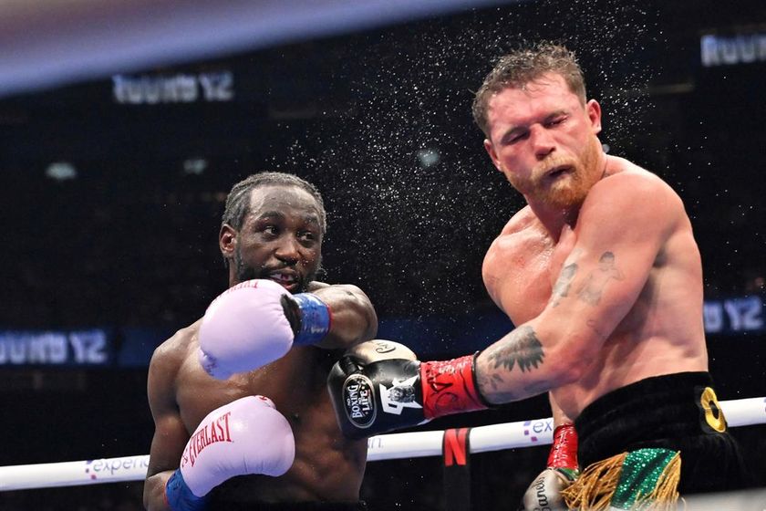 Terence Crawford, left, punches Canelo Alvarez during an undisputed super middleweight championship boxing match in Las Vegas, Saturday, Sept. 13, 2025.